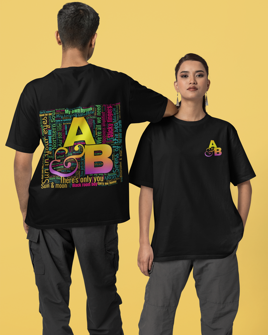 Two people wearing black t-shirts with colorful designs on a yellow background