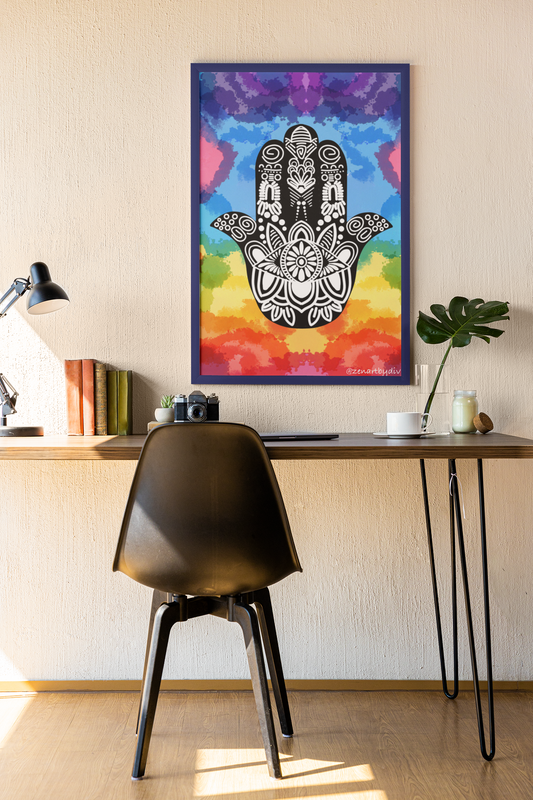 Black and white Hamsa hand art with intricate patterns on rainbow watercolor background in modern workspace