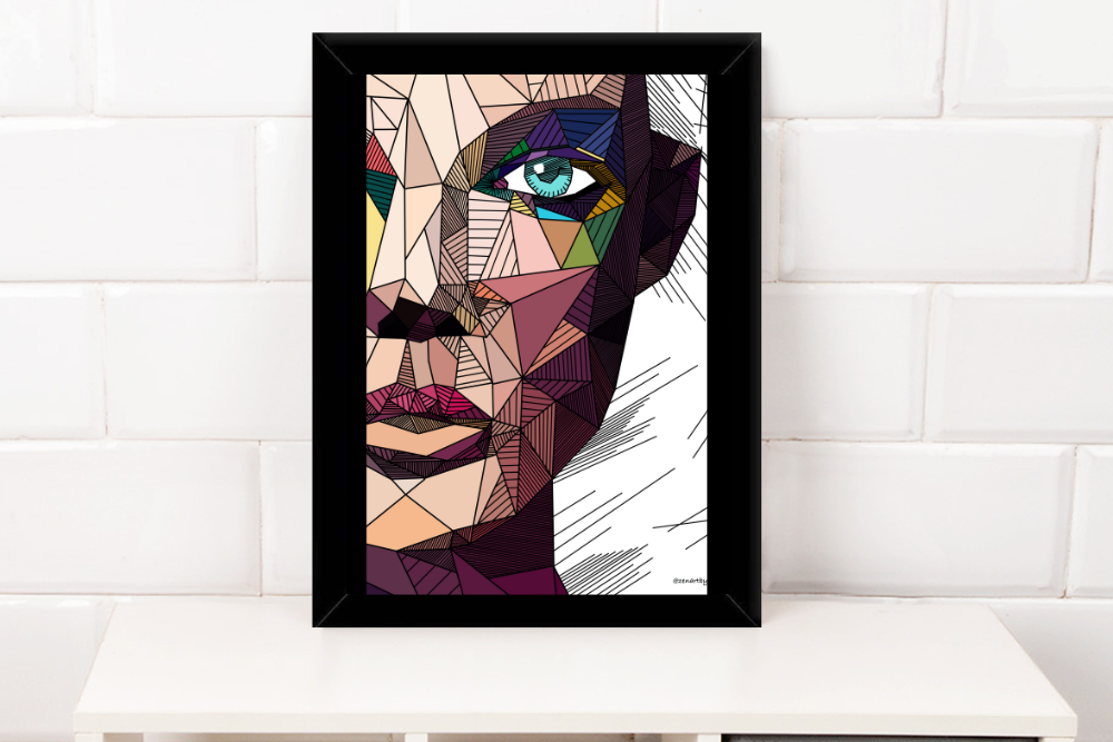 Geometric abstract portrait of a woman's face with blue eye in a black frame on white shelf