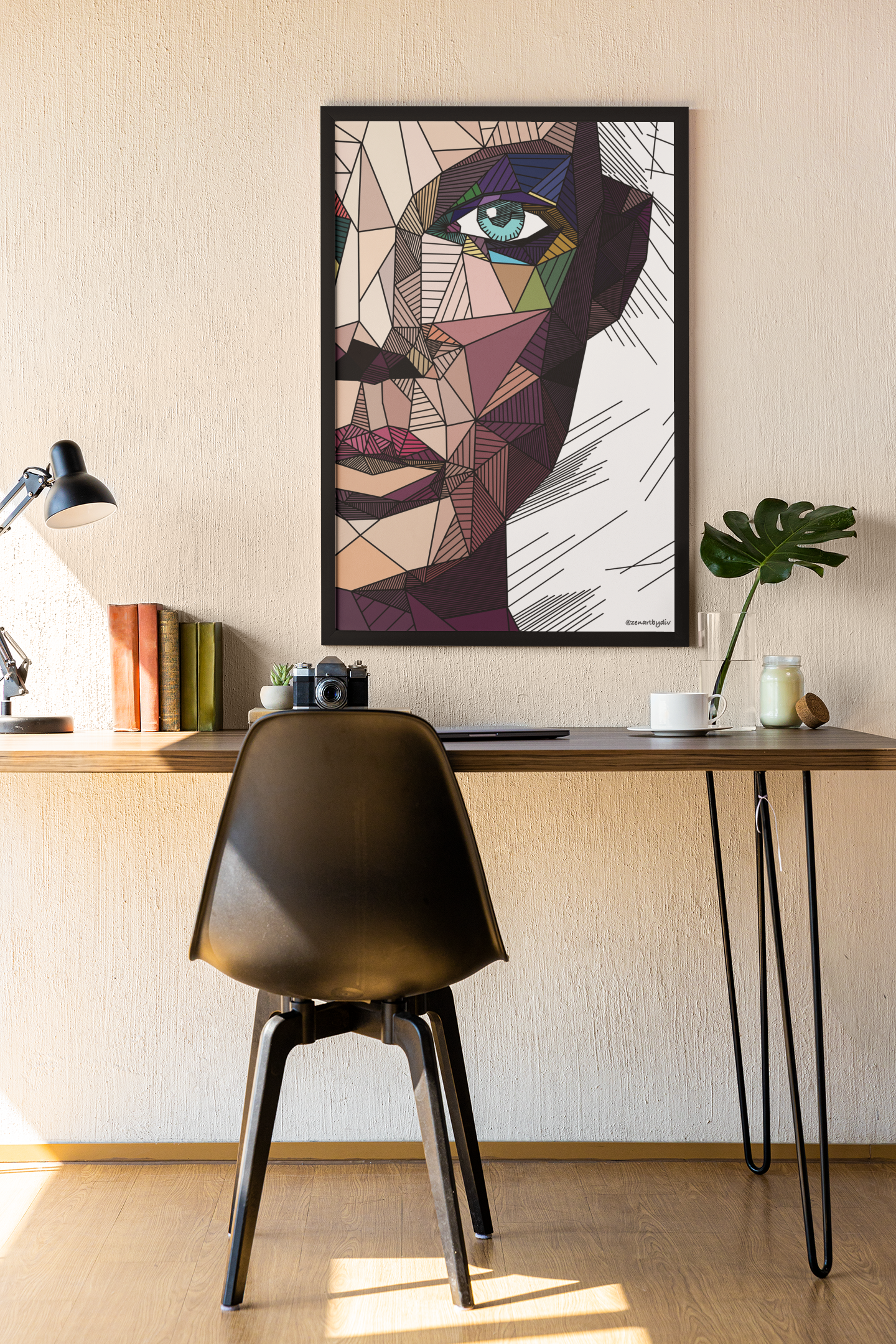 Geometric abstract face portrait wall art above minimal wooden desk with black chair and decorative items