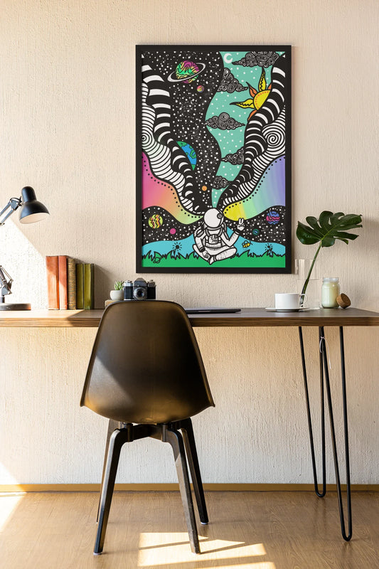 Modern workspace with wooden desk, black chair, lamp, books, camera, plant, and colorful astronaut space art