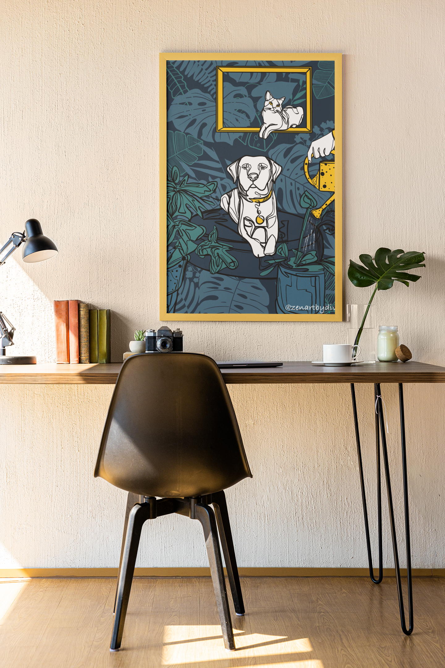 Framed modern art print of a cat and dog with watering can on blue leafy background above minimalist desk setup